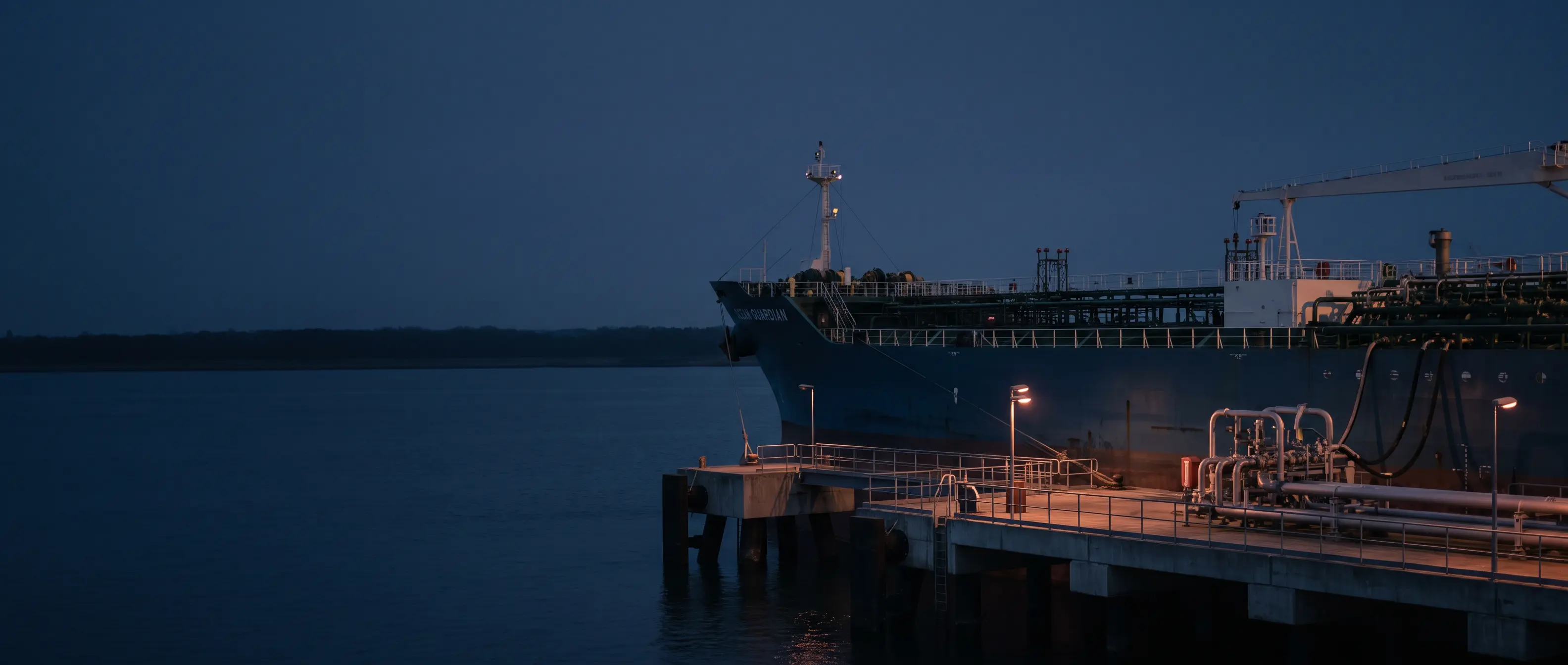 Tanker berthed at an oil terminal in evening light